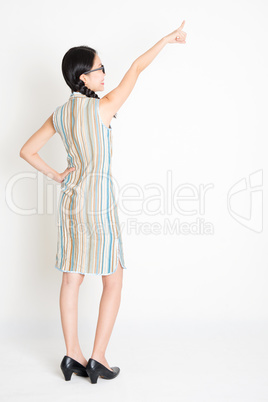 Asian girl pointing away