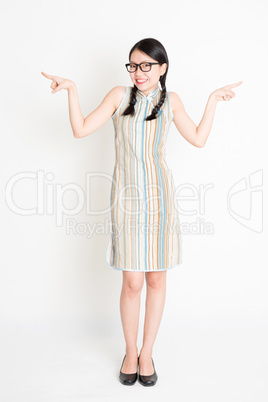 Asian woman fingers pointing at side