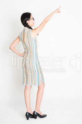 Asian girl pointing at something