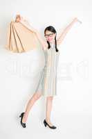 Oriental girl holding shopping paper bag