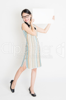 Oriental girl holding white blank paper card