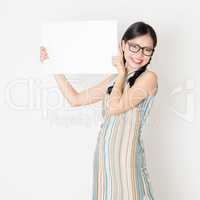 Asian girl holding white blank paper card