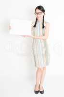 Asian female holding white blank paper card