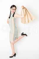 Oriental woman holding shopping paper bag