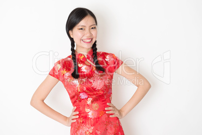 Oriental girl in red qipao smiling