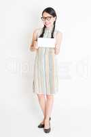 Asian woman holding white blank paper card