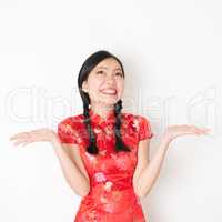 Surprised oriental woman in red qipao
