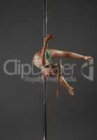 Junior girl balancing on pylon at dance studio