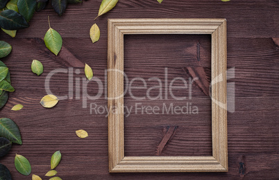 Empty wooden frame on brown wood surface