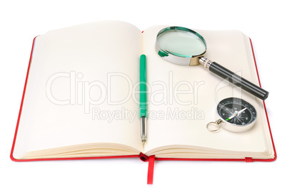 Notebook, magnifying glass and compass isolated on white backgro