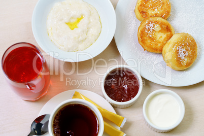 Breakfast table with porridge and cheese pancakes