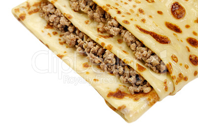 Close-up of pancake with meat isolated on white