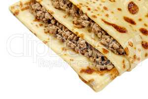 Close-up of pancake with meat isolated on white