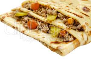 Pancake with meat and vegetables isolated on white