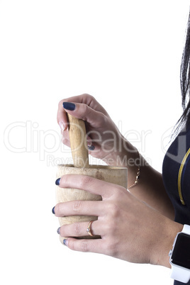 Wooden mortar in female hands