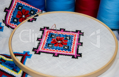 Traditional folk geometric pattern embroidered cross on a white