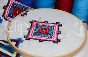 Traditional folk geometric pattern embroidered cross on a white