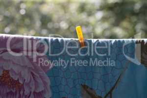 one clothespin on blue bedsheet