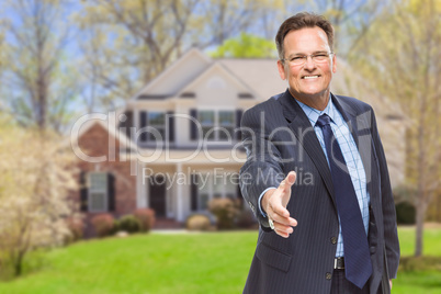 Male Agent Reaching for Hand Shake in Front of House