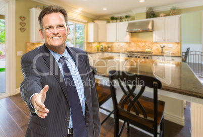 Male Agent Reaching for Hand Shake in New Kitchen