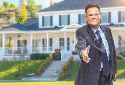 Male Agent Reaching for Hand Shake in Front of House