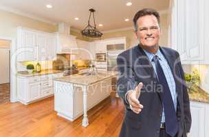 Male Agent Reaching for Hand Shake in New Kitchen