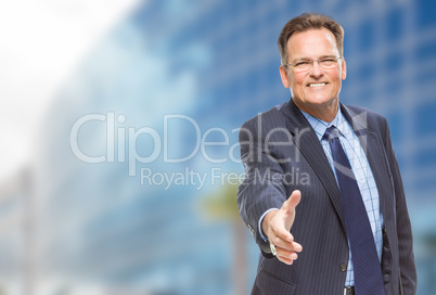 Businessman Reaching for Hand Shake in Front of Building