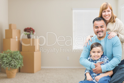 Mixed Race Family with Son in Room with Packed Moving Boxes