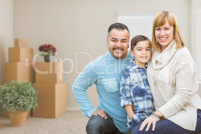Mixed Race Family with Son in Room with Packed Moving Boxes