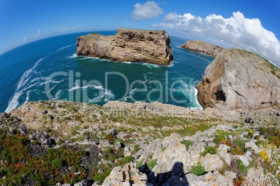 Fisheye view of scenic rocks in the ocean near Cabo de Sao Vicente Cape in the Algarve, Portugal