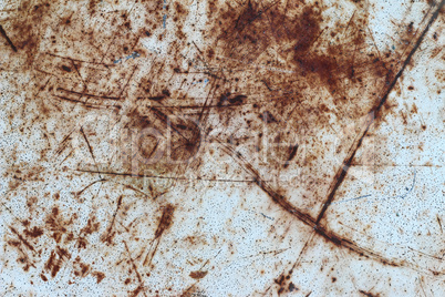 Scratches on the surface of the rusted metal plate