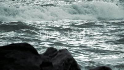 Evening Waves and Defocused Rocks in the Foreground. Slow Motion