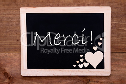 Blackboard With Wooden Hearts, Text Merci Means Thank You
