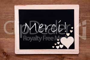 Blackboard With Wooden Hearts, Text Merci Means Thank You
