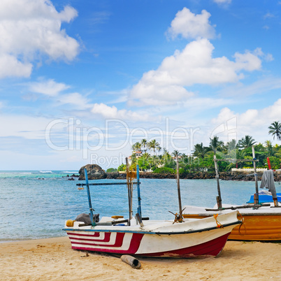 fishing boat on the sandy shore against a background the ocean a