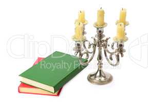 candlestick and books isolated on white background