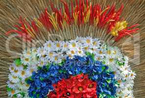 Decoration of artificial flowers and ears of corn.