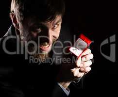 bearded man in business suit gives a ring in the red box and expresses different emotions on dark background