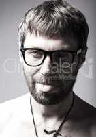 bearded man in glasses plays the fool. crazy boy, funny expression