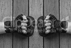 men hands in black leather gloves for Thai boxing