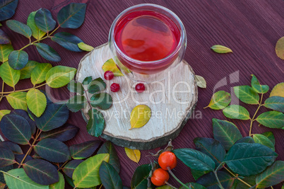 Fruit tea with berries viburnum on a wooden surface