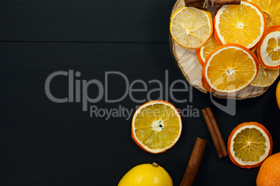 Dried slices of orange and lemon on a wooden surface,