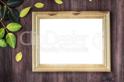 Empty wooden frame on brown wooden surface