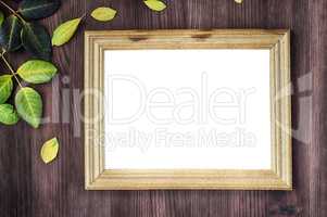 Empty wooden frame on brown wooden surface