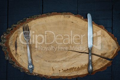 Fork and knife on a wooden frame, the empty space in the middle