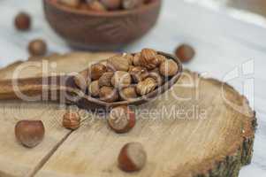 Shelled nuts, hazelnuts in a wooden spoon
