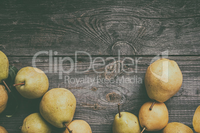 green pears on gray worn wooden background, top view