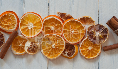 pieces of dried citrus orange and lemon on a white wooden surfac