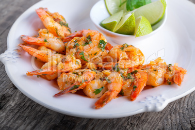 Fried Prawns with lime on a white plate