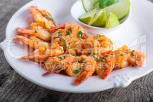 Fried Prawns with lime on a white plate
